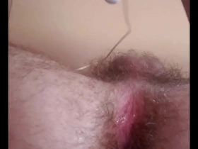 Young gay man masturbates with his finger and vibrator.