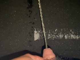 Solo boy urinates at night standing on the road