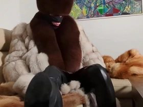 Gay man in hermelin coat and spanking boots