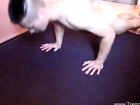 Strong Asian man shows off his muscles at the gym