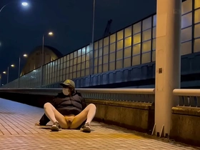 A female sissy named Mayu-chan is walking naked on a bridge at night and gets exposed by passing cars.