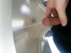 Solo boy urinates in the bathroom