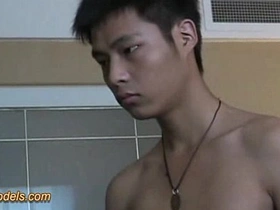 A young and slim Asian man masturbates.