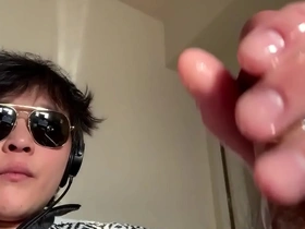 Asian man pleasuring himself for the camera.