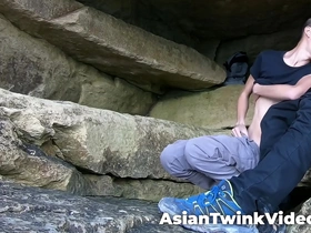 A young Asian and white gay couple makes love in a lagoon.