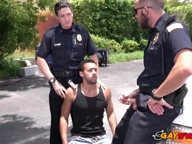 Hot gay cops get a blowjob from a bad boy in a threesome in an alley.