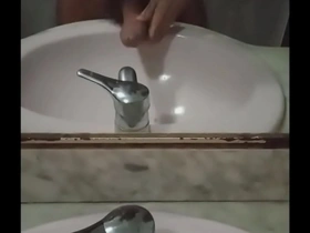 Femboy with a long moustache pleasuring himself in front of the mirror