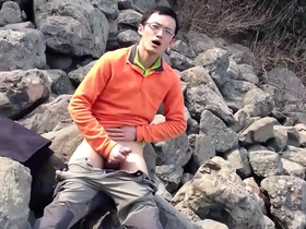 Skinny gay Chinese guy masturbates outdoors.