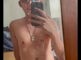 Skinny Asian boy masturbates in front of a mirror.
